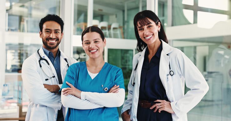 Three doctors looking at camera